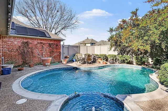 a view of a house with swimming pool and sitting area