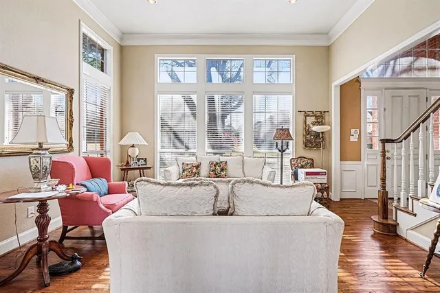 a living room with fireplace furniture and a large window