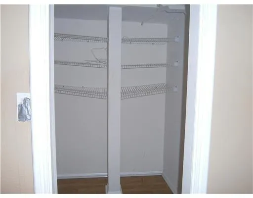 an empty room with a chandelier fan