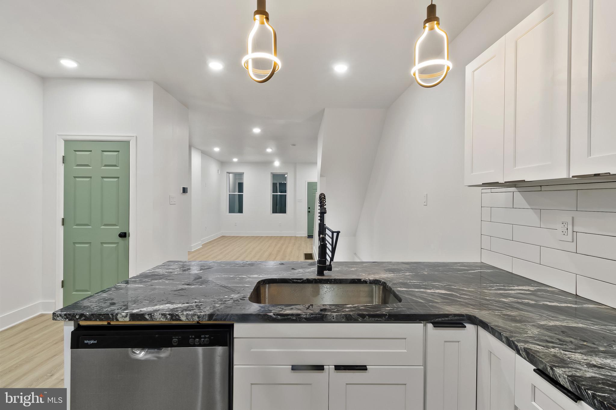 5214 Jefferson Street Philadelphia, PA 19131 - Photo 11 of 28 a kitchen with granite countertop a sink a counter space and cabinets