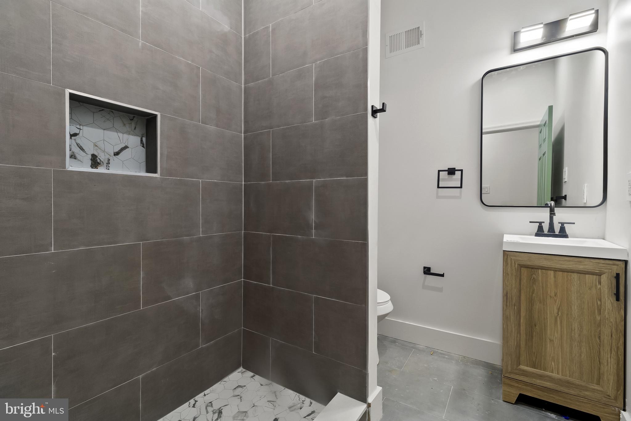 5214 Jefferson Street Philadelphia, PA 19131 - Photo 17 of 28 a bathroom with a sink a toilet and mirror