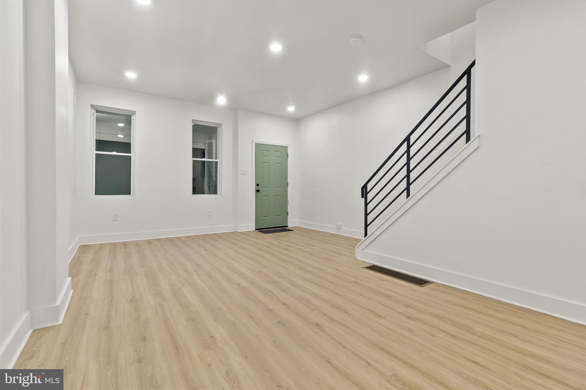5214 Jefferson Street Philadelphia, PA 19131 - Photo 7 of 28 a view of an empty room with wooden floor and stairs