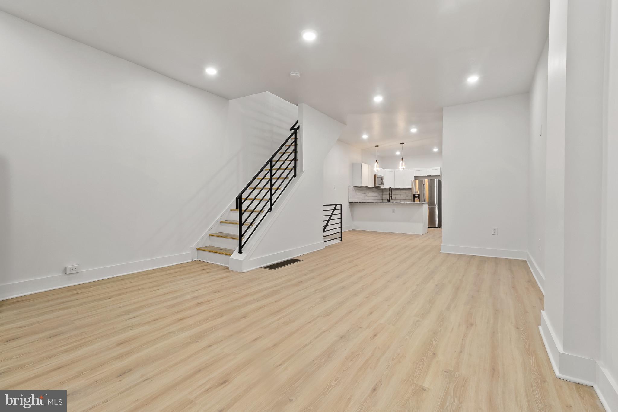 5214 Jefferson Street Philadelphia, PA 19131 - Photo 8 of 28 a view of an empty room with wooden floor and stairs