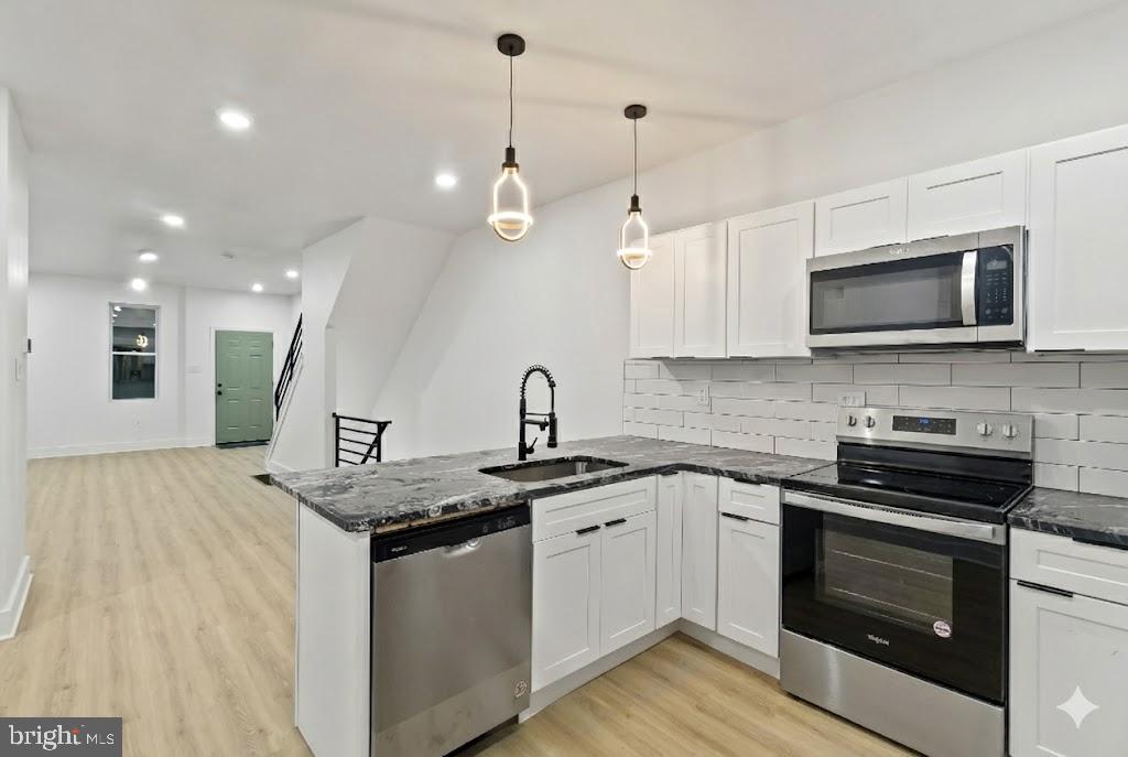 5214 Jefferson Street Philadelphia, PA 19131 - Photo 10 of 28 a kitchen with stainless steel appliances a stove sink microwave and cabinets