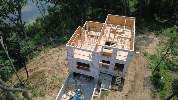 aerial view of a house with a yard