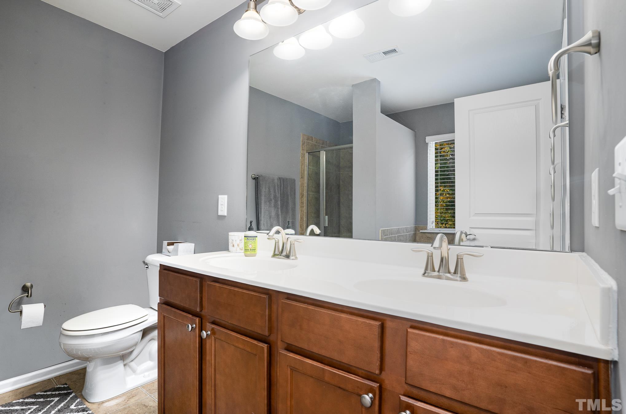 3608 Althorp Drive Raleigh, NC 27616 - Photo 15 of 25 a bathroom with a sink toilet and mirror