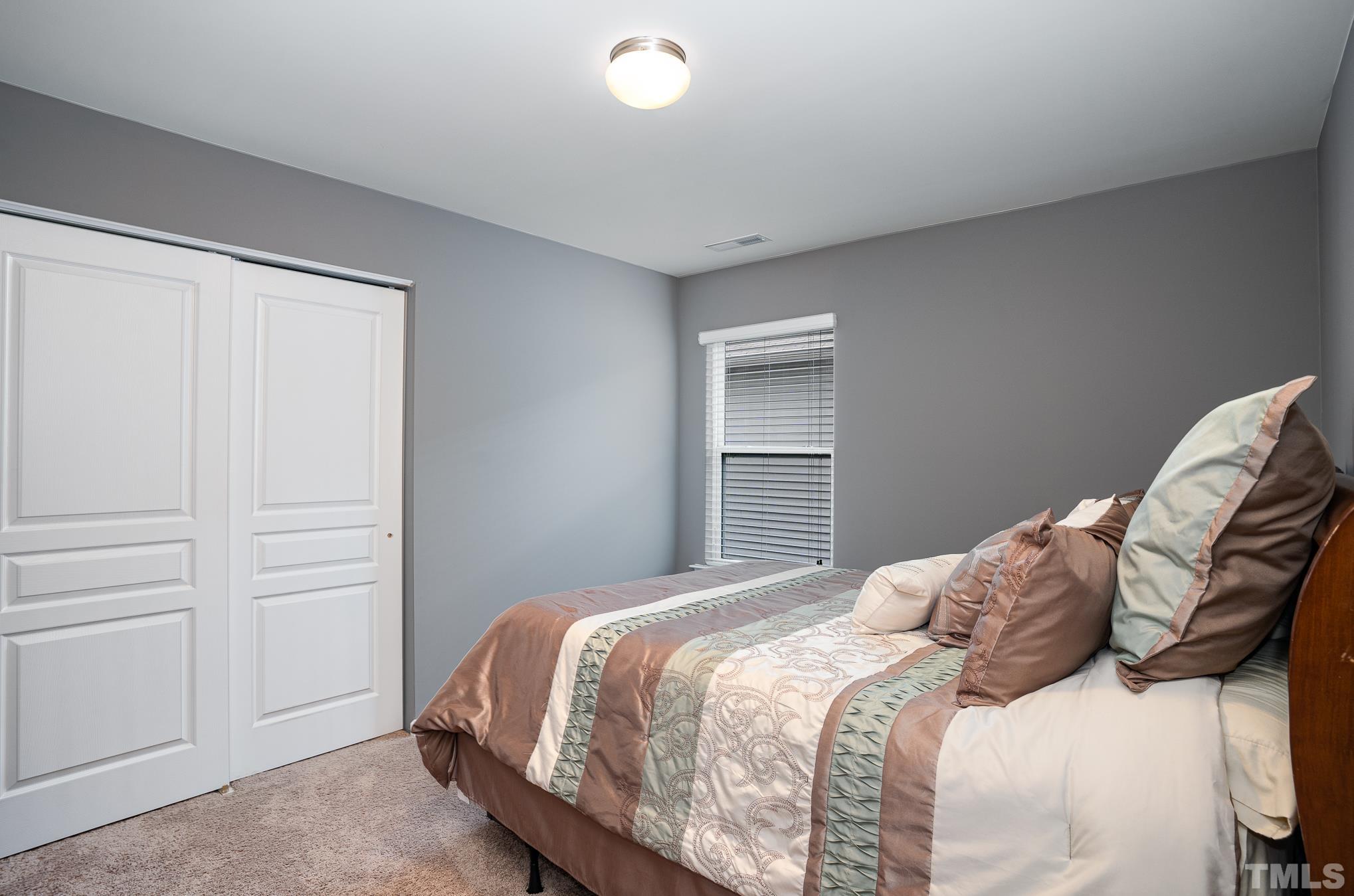 3608 Althorp Drive Raleigh, NC 27616 - Photo 17 of 25 a bedroom with a bed and a window