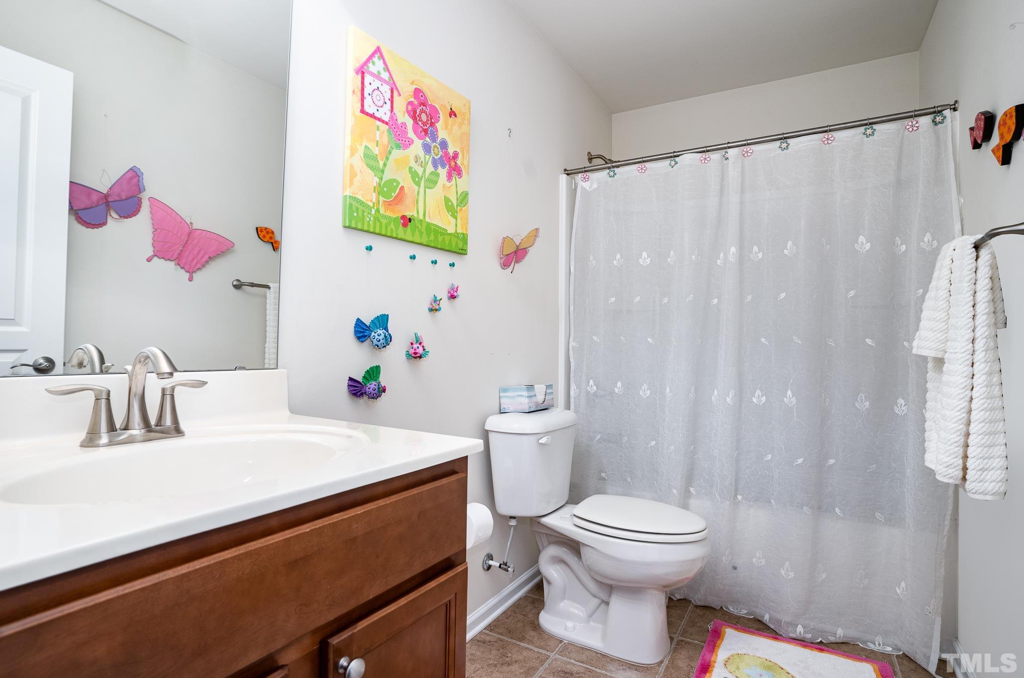 3608 Althorp Drive Raleigh, NC 27616 - Photo 18 of 25 a bathroom with a sink a toilet and a shower