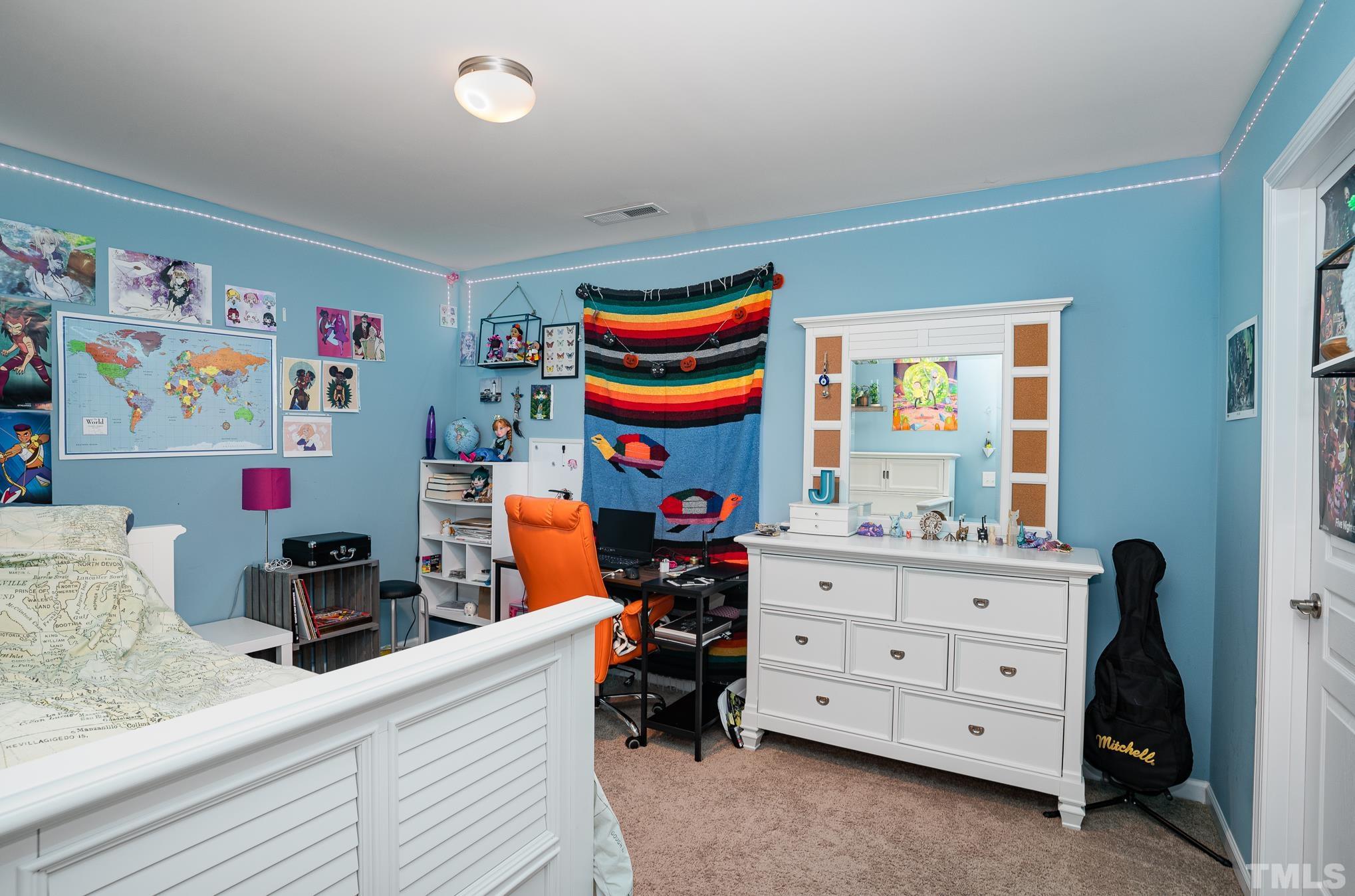 3608 Althorp Drive Raleigh, NC 27616 - Photo 19 of 25 a bedroom with a bed and furniture