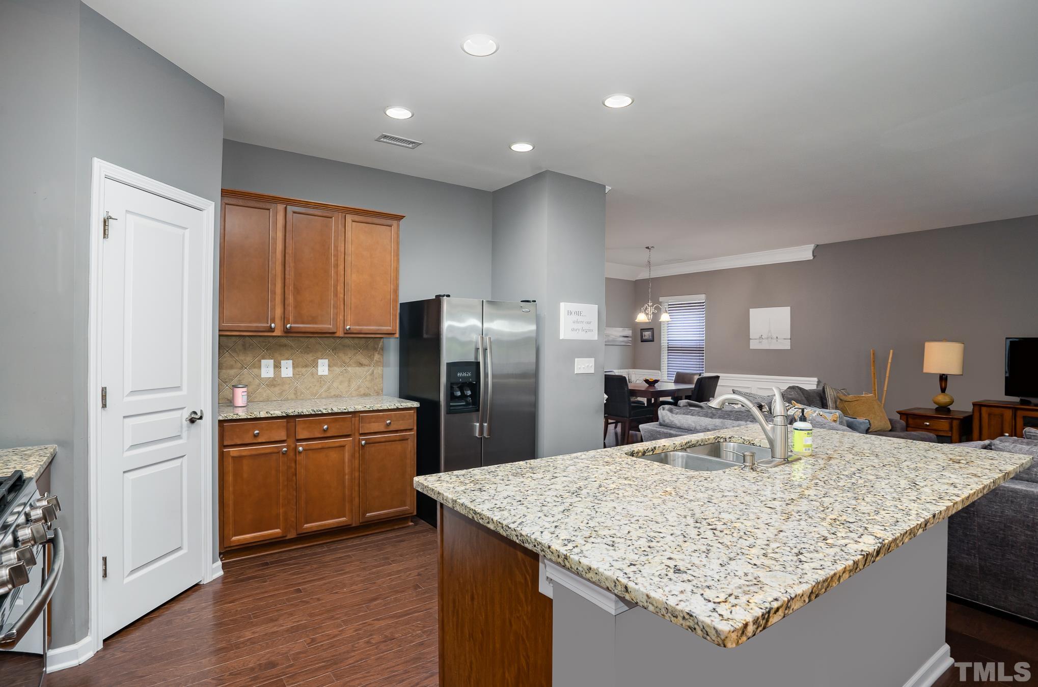 3608 Althorp Drive Raleigh, NC 27616 - Photo 7 of 25 a kitchen with stainless steel appliances granite countertop a sink refrigerator and cabinets