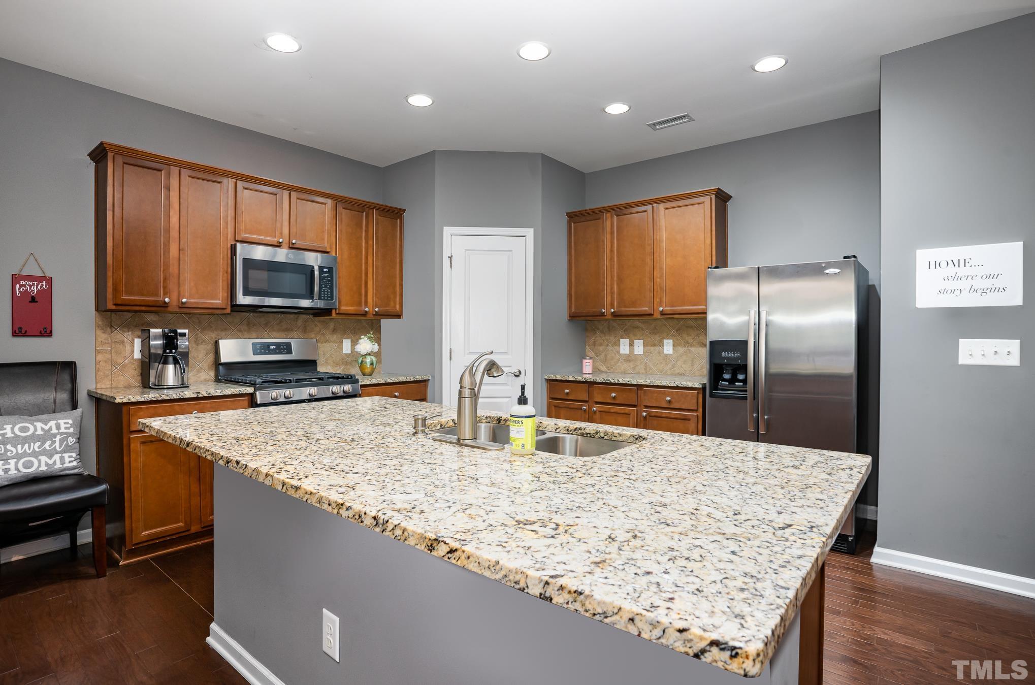 3608 Althorp Drive Raleigh, NC 27616 - Photo 8 of 25 a kitchen with stainless steel appliances granite countertop a sink refrigerator and microwave