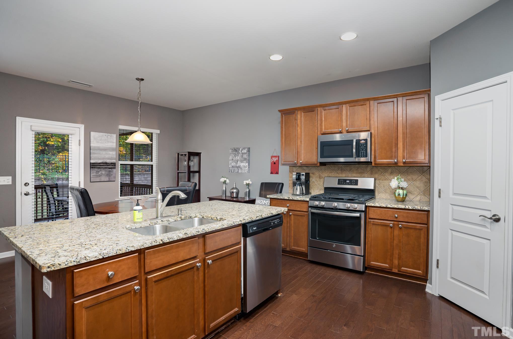 3608 Althorp Drive Raleigh, NC 27616 - Photo 9 of 25 a kitchen with a stove sink and microwave