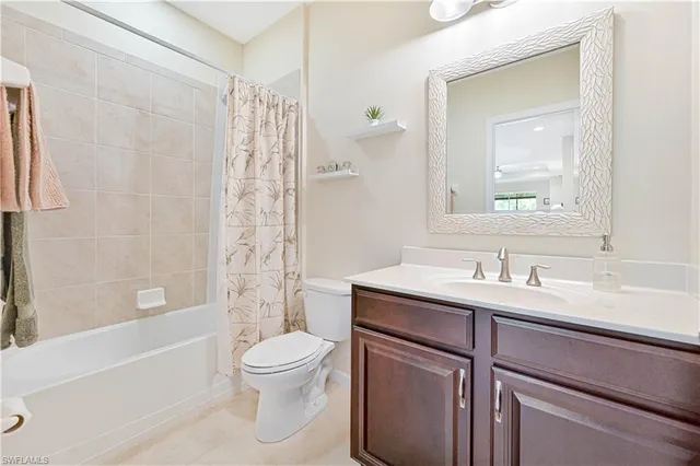 a living room with furniture a rug and a bookshelf