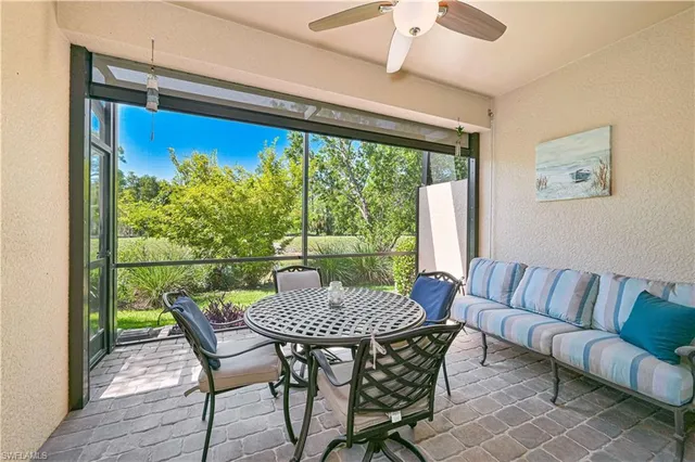 a view of a house with a big yard and large windows
