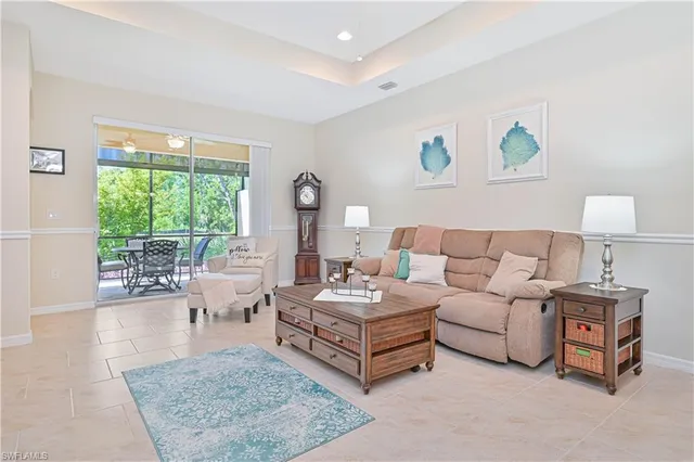 a living room with furniture a window and a chandelier