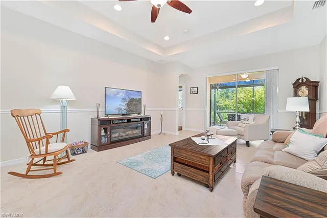 a living room with furniture and a view of kitchen