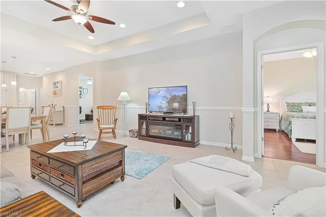 a kitchen with a refrigerator a microwave oven dining table and chairs