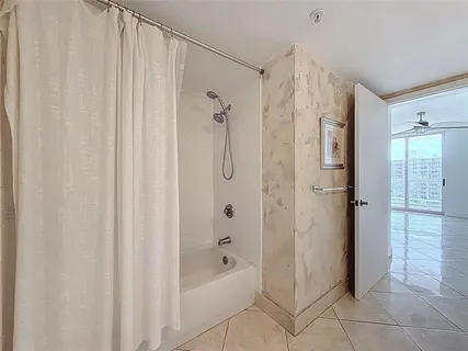 a bathroom with a shower and a tub