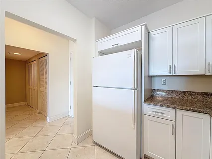 a white refrigerator freezer sitting inside of a kitchen