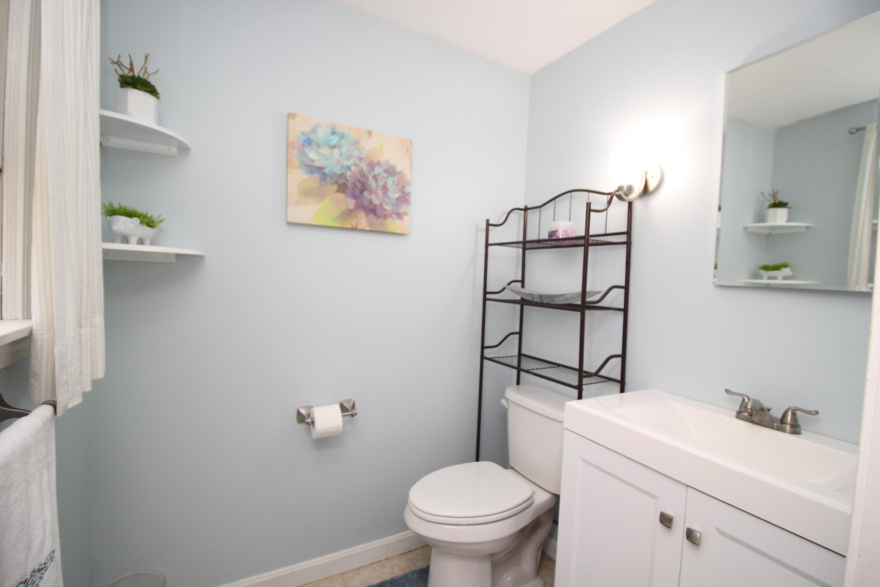 568 Skunknet Road Centerville, MA 02632 - Photo 15 of 18 a white toilet sitting next to a bathroom sink