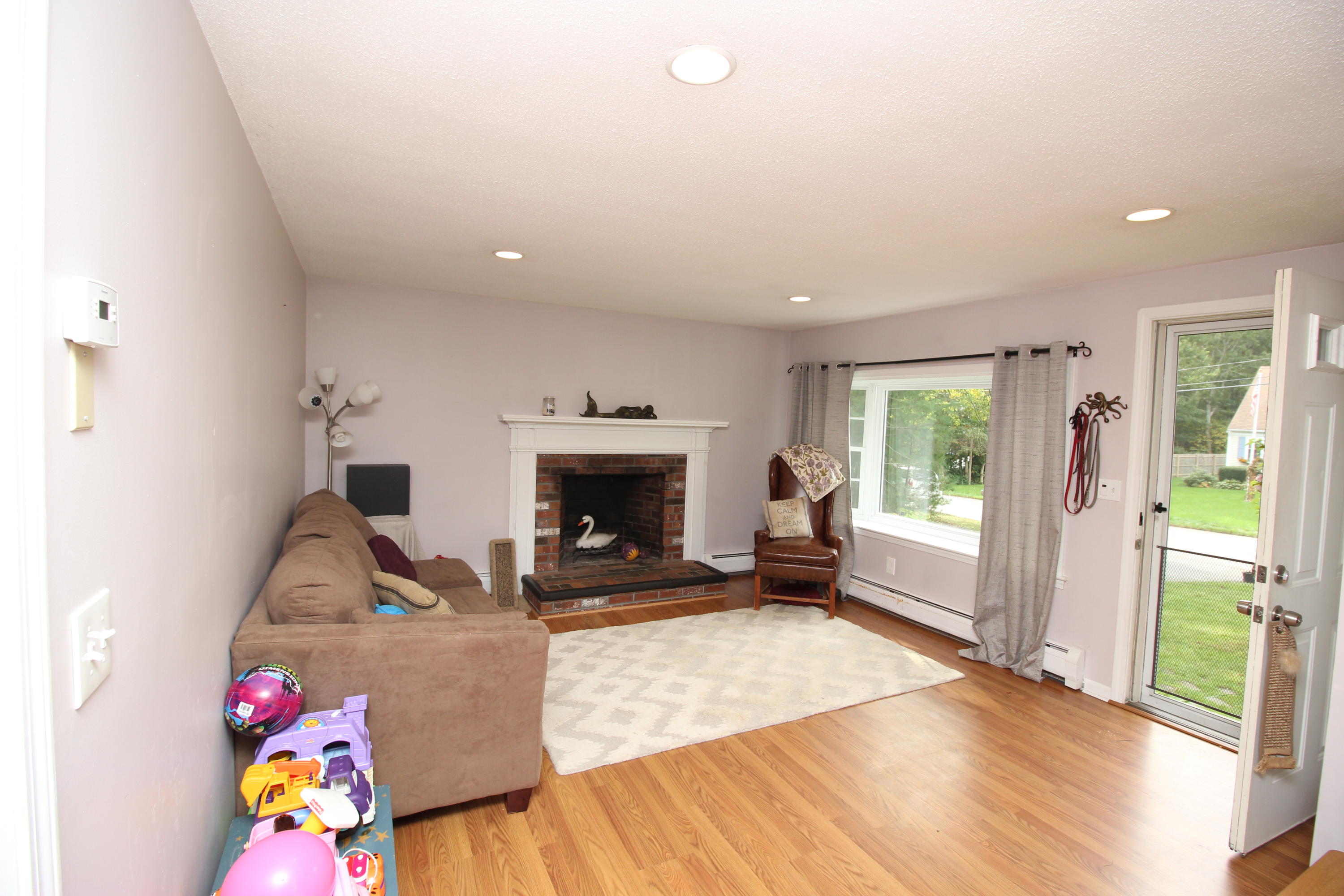 568 Skunknet Road Centerville, MA 02632 - Photo 6 of 18 a living room with furniture and a fireplace