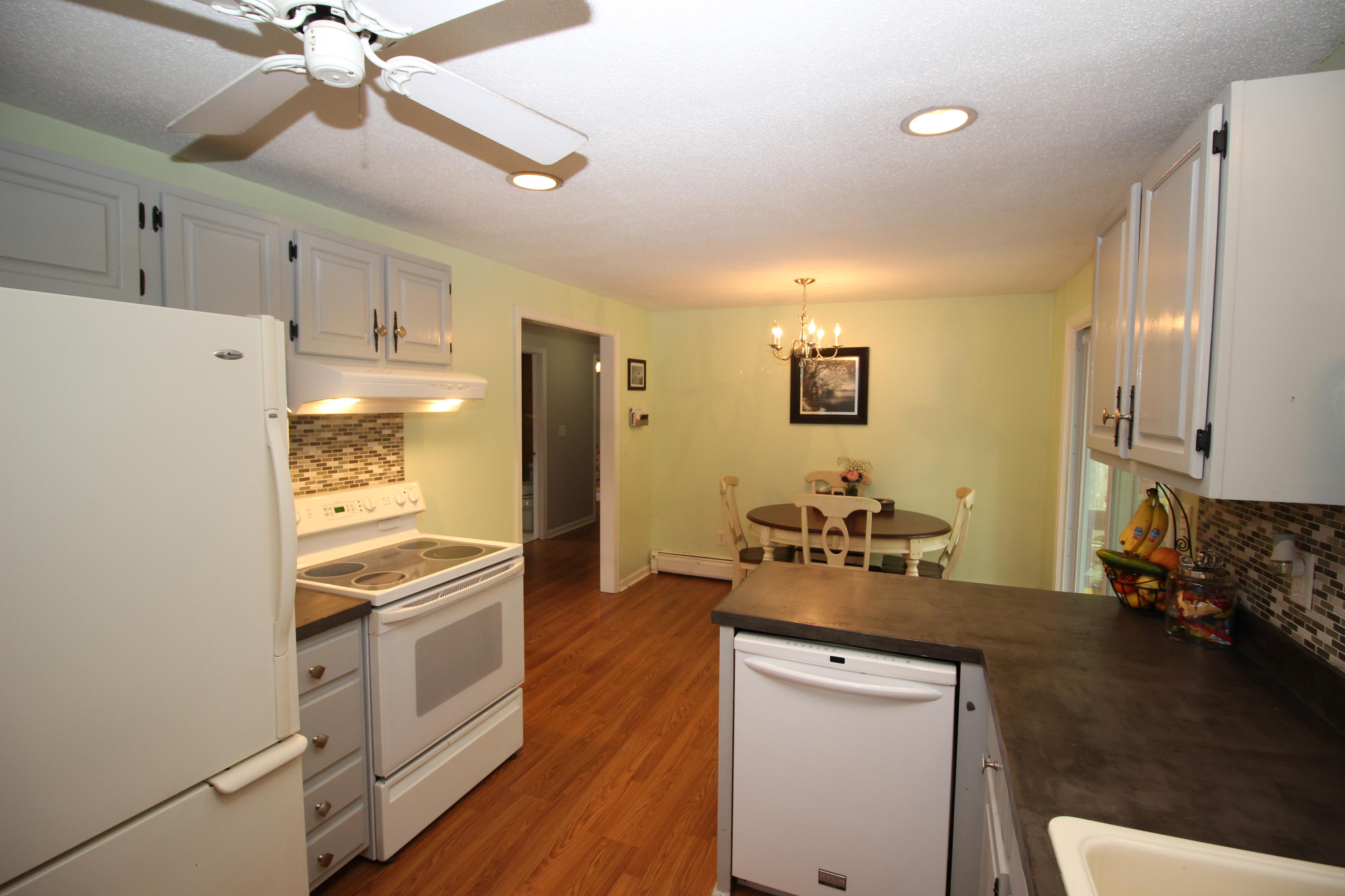 568 Skunknet Road Centerville, MA 02632 - Photo 10 of 18 a kitchen with a refrigerator and a stove