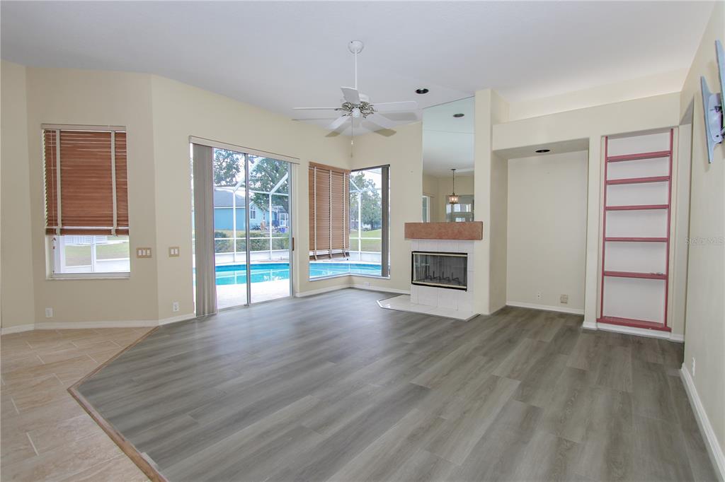 2319 Sunview Avenue Valrico, FL 33596 - Photo 26 of 41 an empty room with wooden floor a fireplace and windows