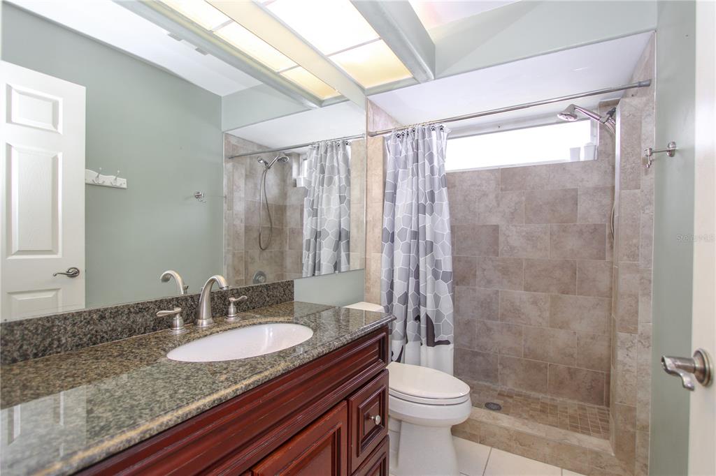 2319 Sunview Avenue Valrico, FL 33596 - Photo 29 of 41 a bathroom with a granite countertop sink toilet and shower