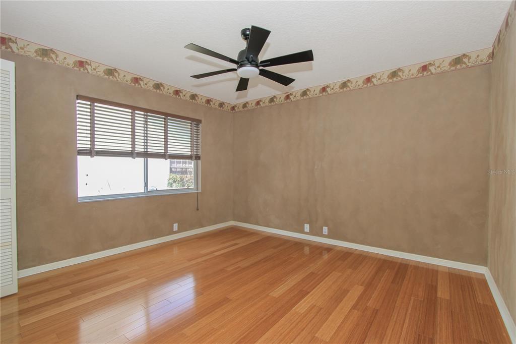 2319 Sunview Avenue Valrico, FL 33596 - Photo 30 of 41 an empty room with wooden floor fan and windows