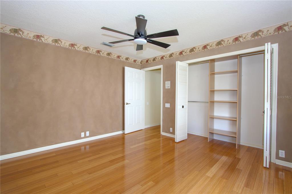 2319 Sunview Avenue Valrico, FL 33596 - Photo 31 of 41 a view of empty room with wooden floor and ceiling fan