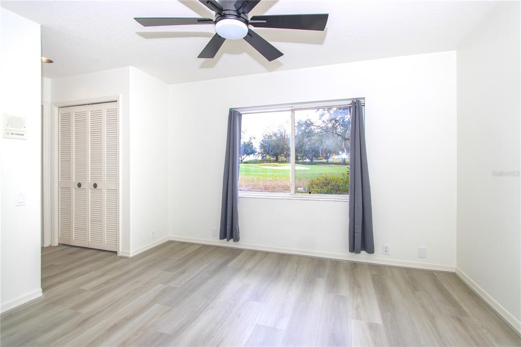 2319 Sunview Avenue Valrico, FL 33596 - Photo 32 of 41 an empty room with wooden floor fan and windows