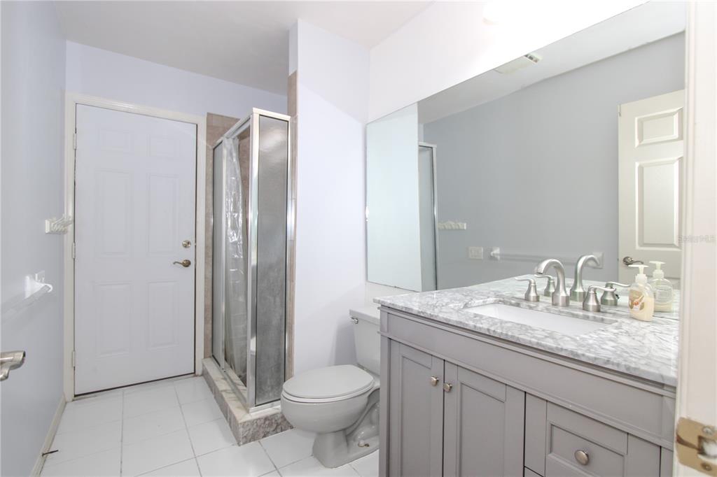 2319 Sunview Avenue Valrico, FL 33596 - Photo 35 of 41 a bathroom with a granite countertop sink toilet and shower