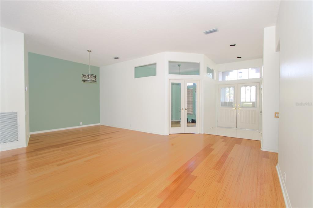 2319 Sunview Avenue Valrico, FL 33596 - Photo 7 of 41 a view of a big room with wooden floor and windows