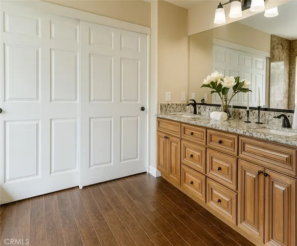 a bathroom with a granite countertop sink and a mirror