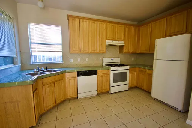 a kitchen with a white cabinets and white appliances