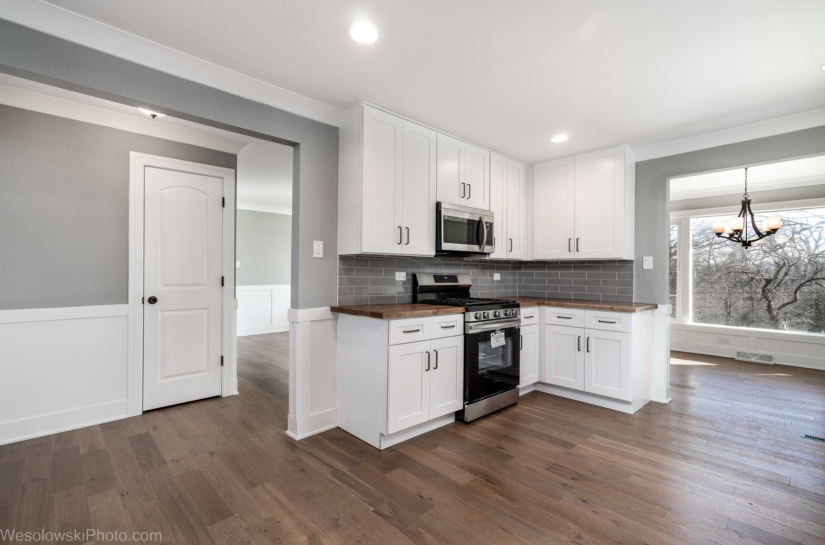 820 Exmoor Road Olympia Fields, IL 60461 - Photo 12 of 35 a kitchen with wooden floors and white appliances