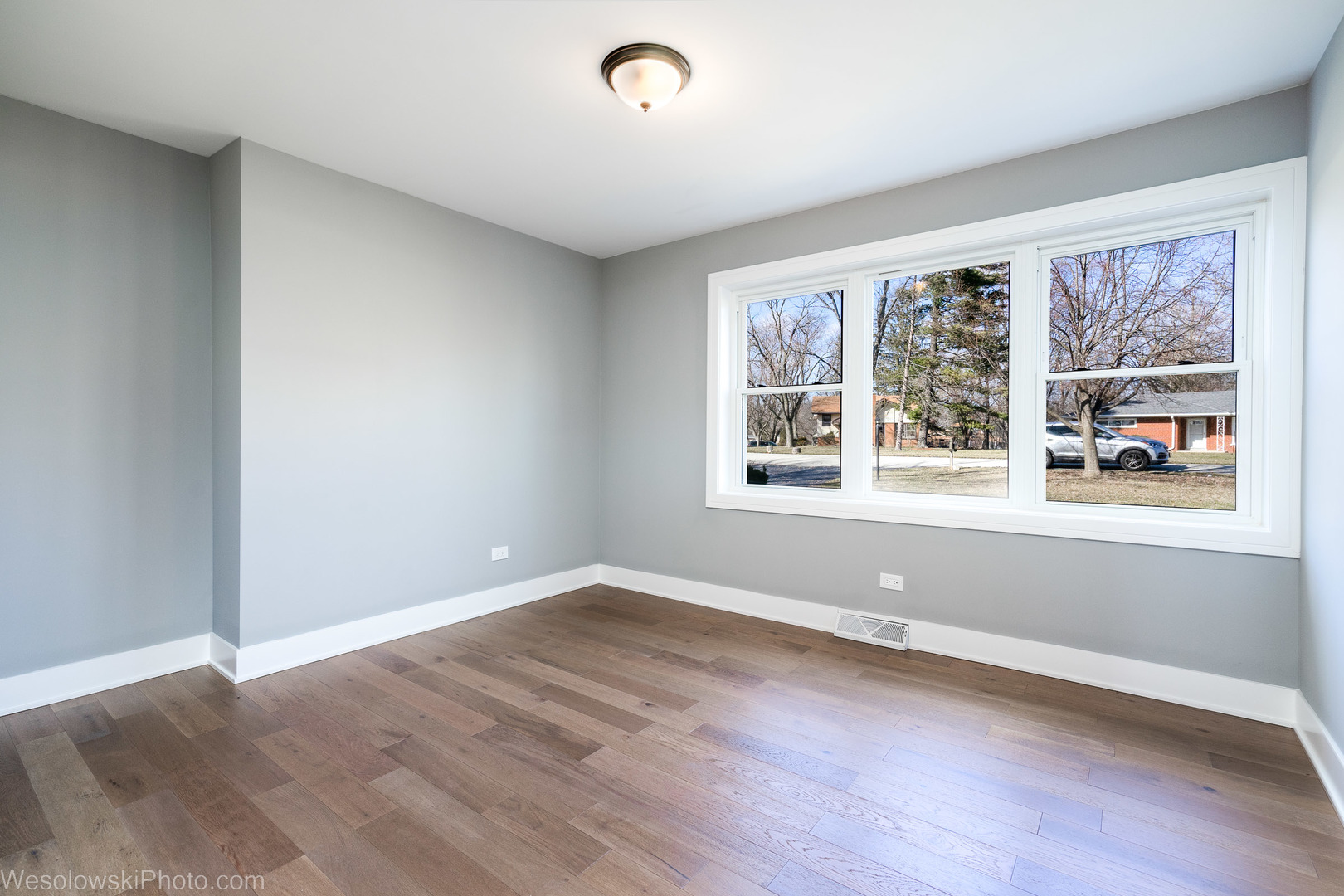 820 Exmoor Road Olympia Fields, IL 60461 - Photo 13 of 35 an empty room with wooden floor and windows