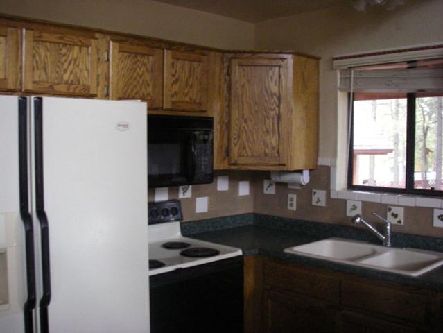 2939 Ransack Road Overgaard, AZ 85933 - Photo 5 of 5 a kitchen with a sink and a refrigerator