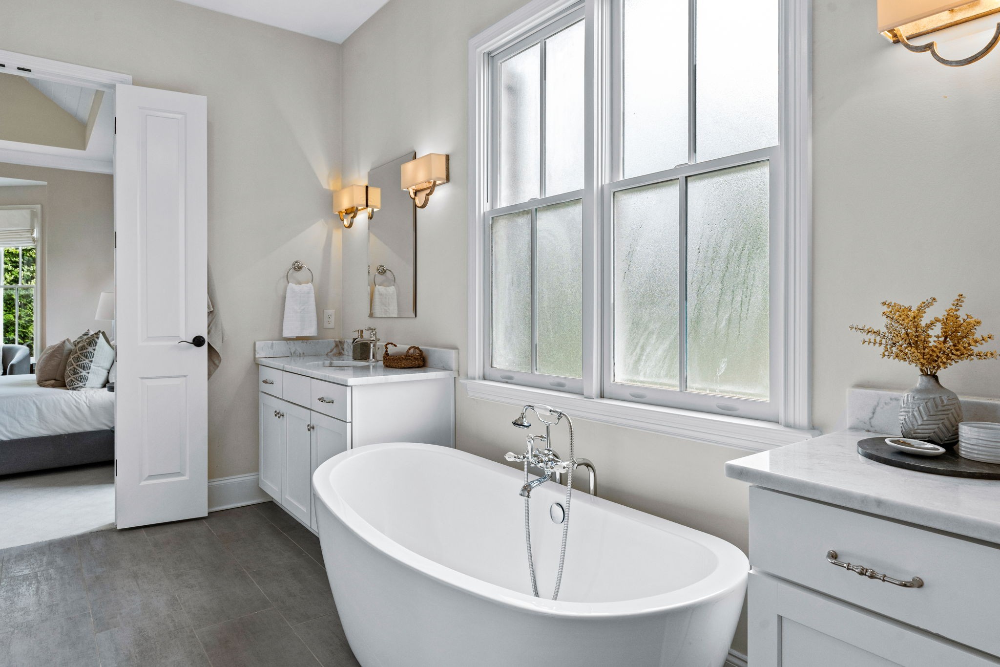 4048 General Martin Lane Franklin, TN 37064 - Photo 23 of 57 a bathroom with a double vanity sink a mirror and a bathtub