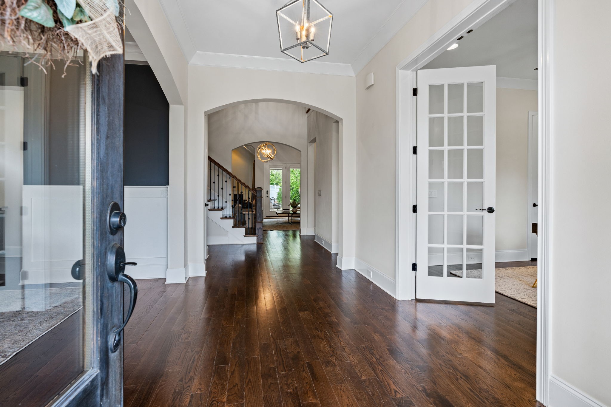 4048 General Martin Lane Franklin, TN 37064 - Photo 6 of 57 a view of a hallway with wooden floor and a living room