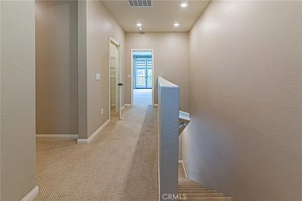 a view of hallway with wooden floor