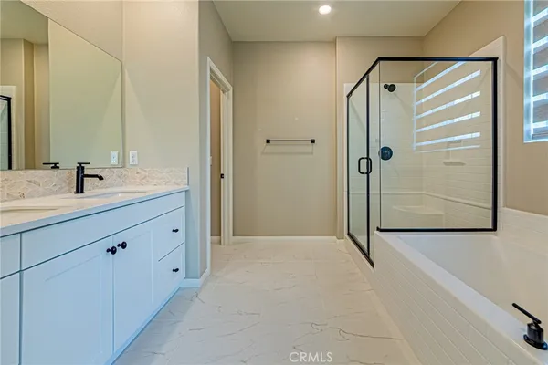 a spacious bathroom with a double vanity sink toilet and a mirror