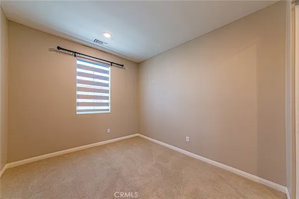 an empty room with closet area