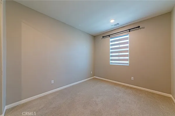 a bathroom with a sink a toilet a mirror and shower