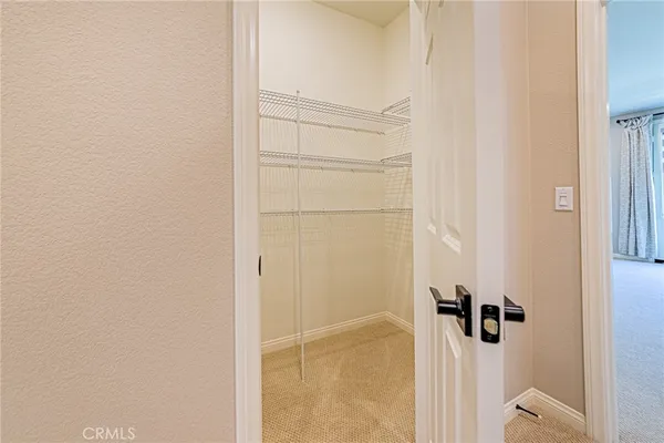 a view of hallway with a livingroom and a bathroom