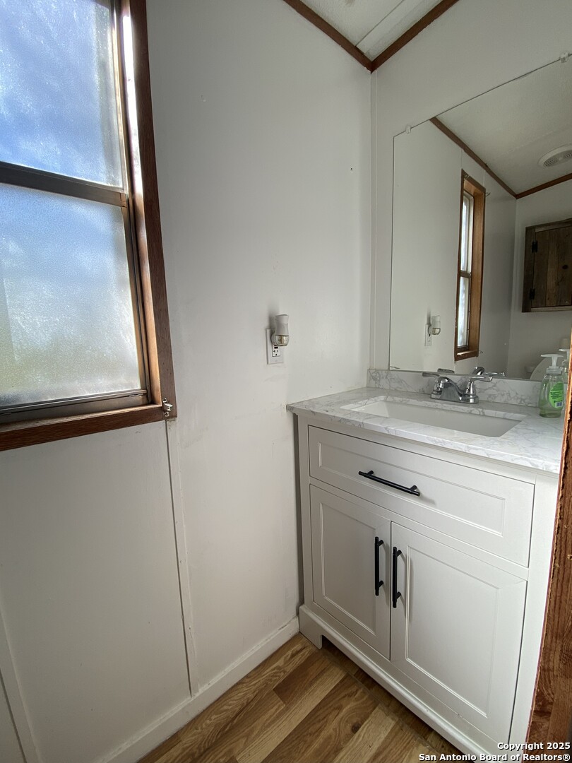 113 Lake Mertzon, TX 76941 - Photo 11 of 14 a view with granite countertop a sink and a mirror
