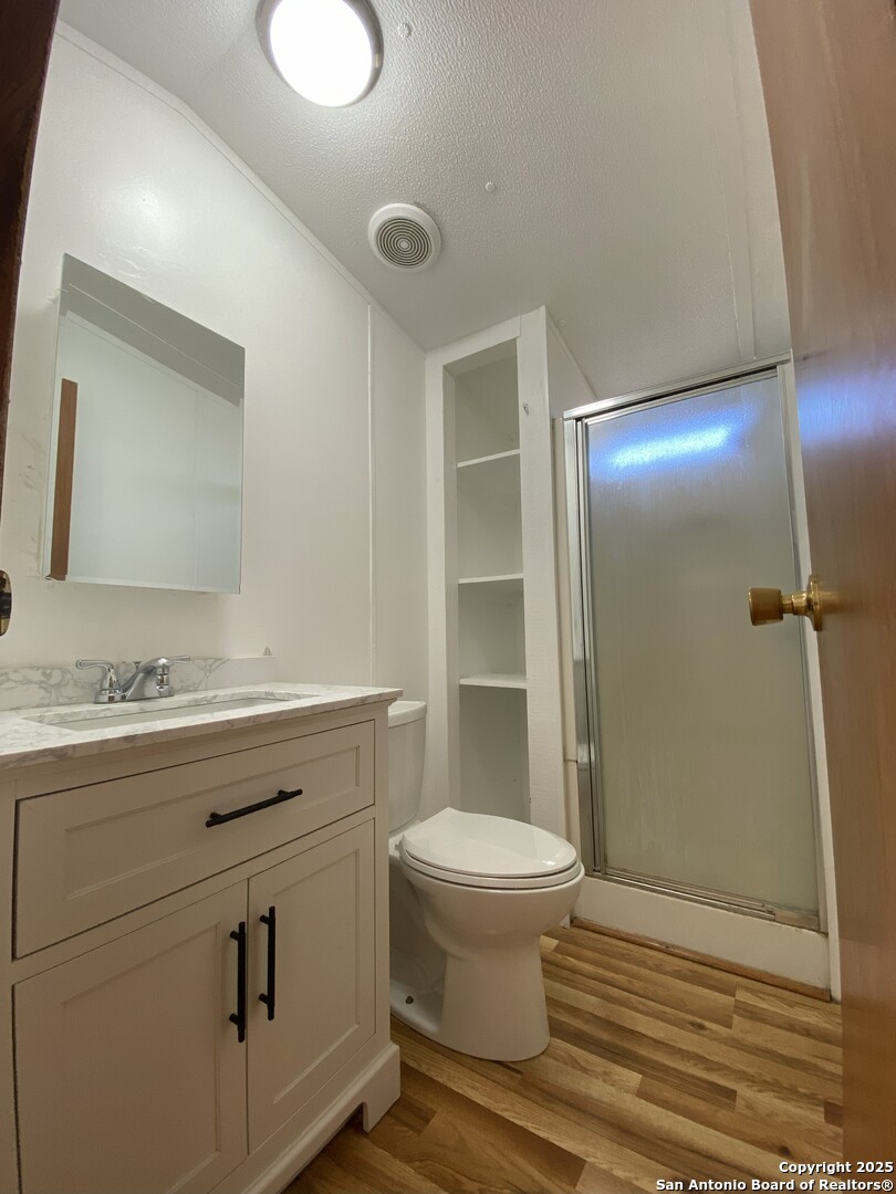 113 Lake Mertzon, TX 76941 - Photo 14 of 14 a bathroom with a granite countertop sink toilet and shower