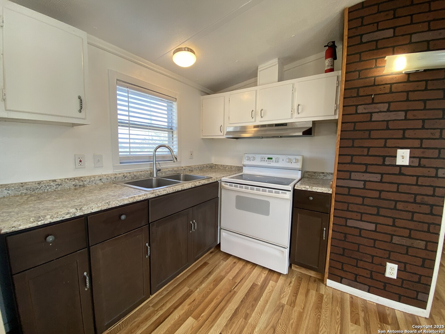 113 Lake Mertzon, TX 76941 - Photo 5 of 14 a kitchen with a sink stove and cabinets