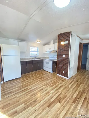 a large kitchen with kitchen island a sink stainless steel appliances and cabinets