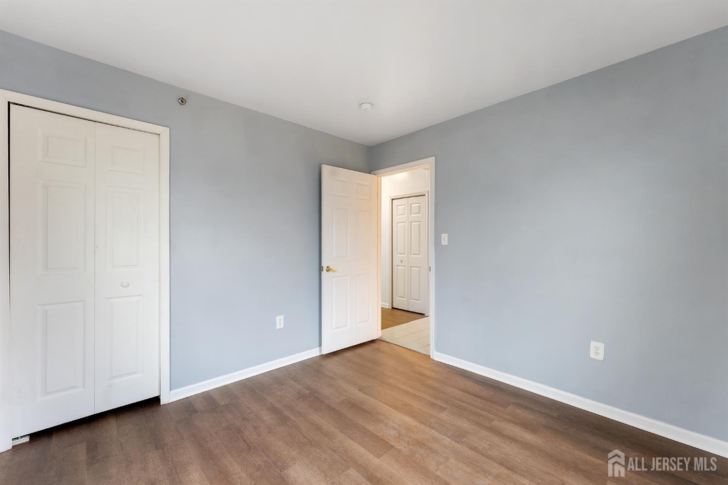 128 Remsen Avenue, Unit A New Brunswick, NJ 08901 - Photo 12 of 18 a view of an empty room with wooden floor